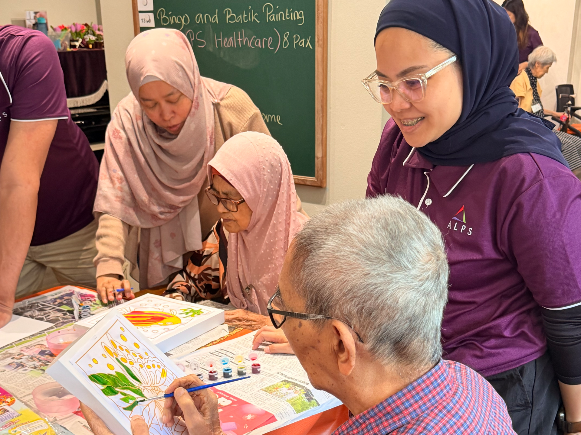 Image of ALPS volunteers at HCA Oasis @ Woodlands Day Hospice, interacting with patients